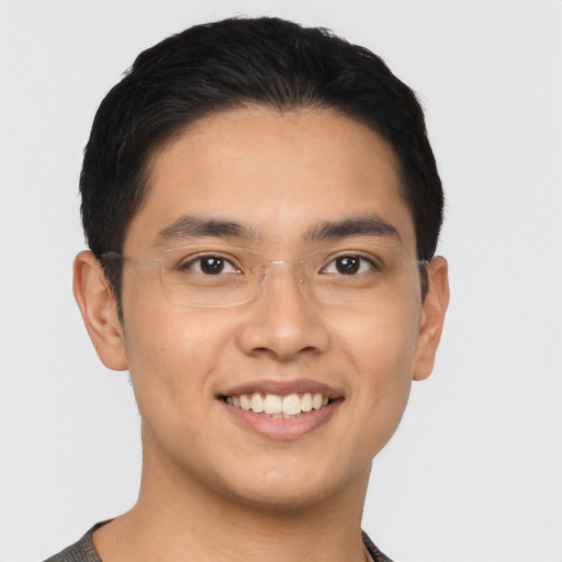 Joyful asian young-adult male with short  brown hair and brown eyes