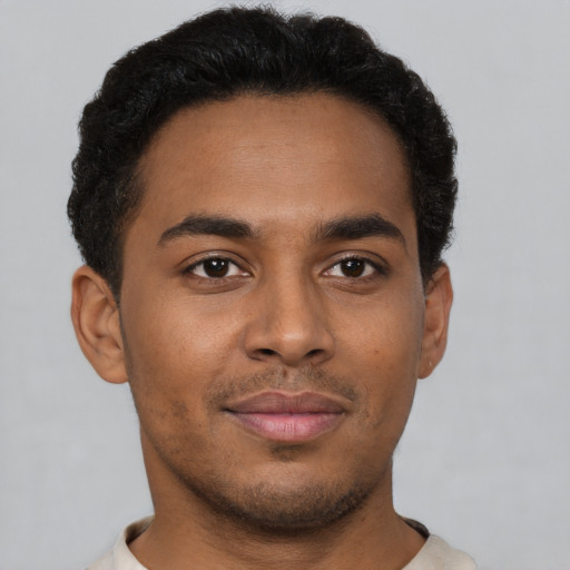 Joyful latino young-adult male with short  brown hair and brown eyes