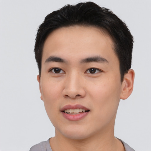 Joyful asian young-adult male with short  black hair and brown eyes