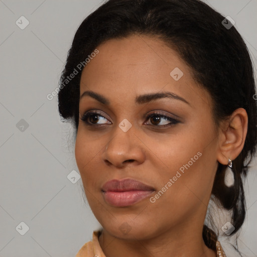 Joyful black young-adult female with medium  brown hair and brown eyes