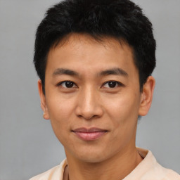 Joyful asian young-adult male with short  black hair and brown eyes