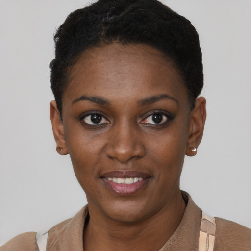 Joyful black young-adult female with short  black hair and brown eyes