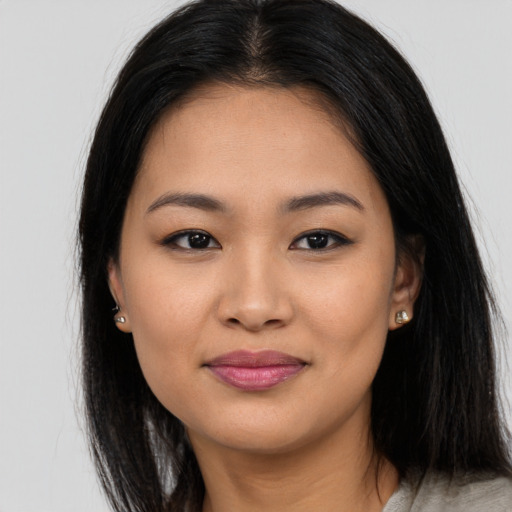 Joyful asian young-adult female with long  brown hair and brown eyes