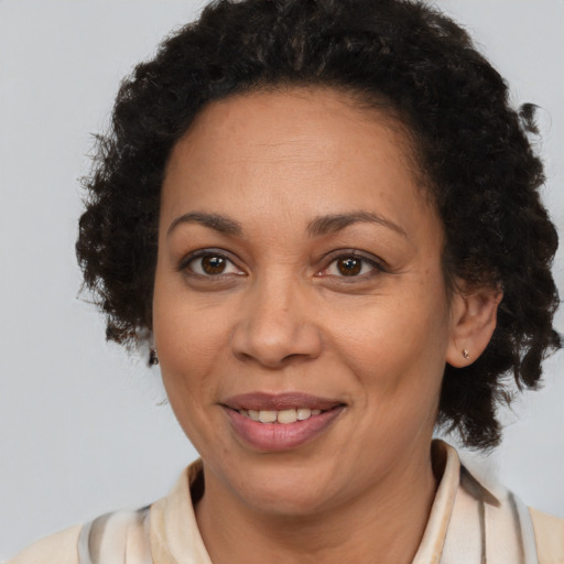 Joyful black adult female with medium  brown hair and brown eyes