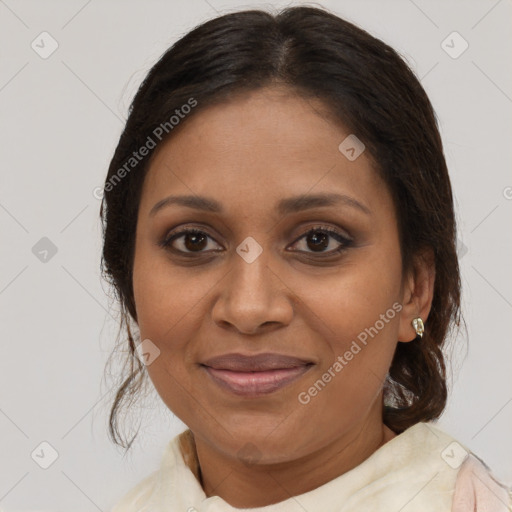 Joyful black adult female with medium  brown hair and brown eyes