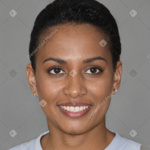 Joyful black young-adult female with short  black hair and brown eyes