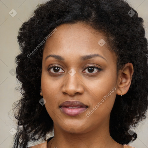 Joyful black young-adult female with long  black hair and brown eyes