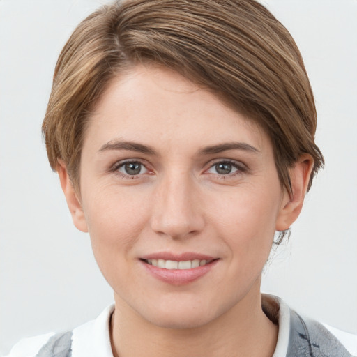 Joyful white young-adult female with short  brown hair and grey eyes