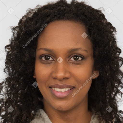 Joyful black young-adult female with long  brown hair and brown eyes