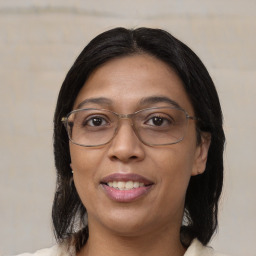 Joyful asian adult female with medium  brown hair and brown eyes