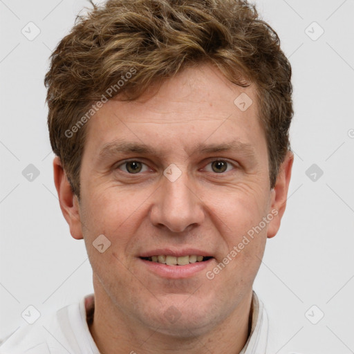 Joyful white adult male with short  brown hair and grey eyes