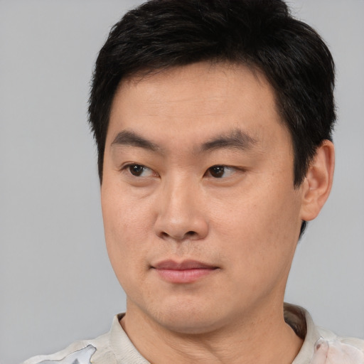 Neutral asian young-adult male with short  brown hair and brown eyes