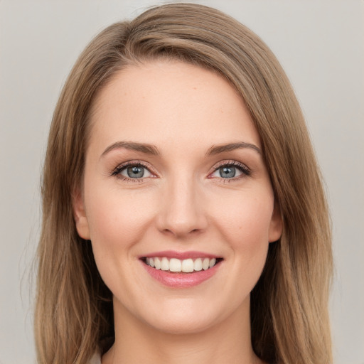 Joyful white young-adult female with long  brown hair and green eyes