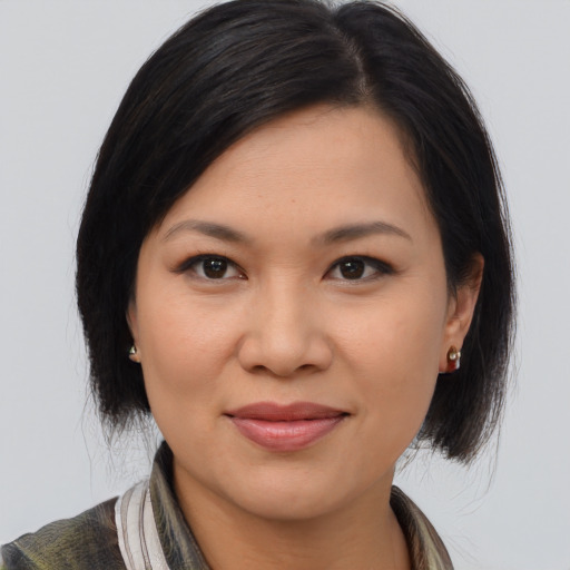 Joyful asian young-adult female with medium  brown hair and brown eyes