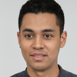 Joyful white young-adult male with short  black hair and brown eyes