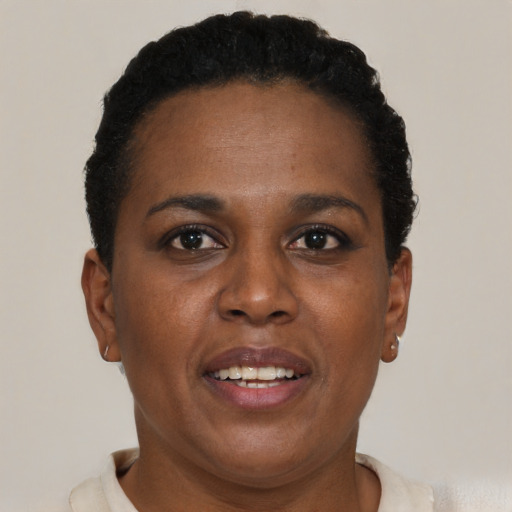 Joyful black adult female with short  brown hair and brown eyes