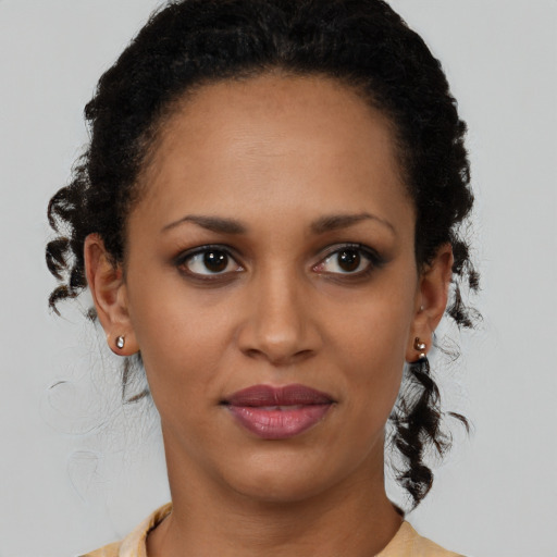 Joyful latino young-adult female with medium  brown hair and brown eyes
