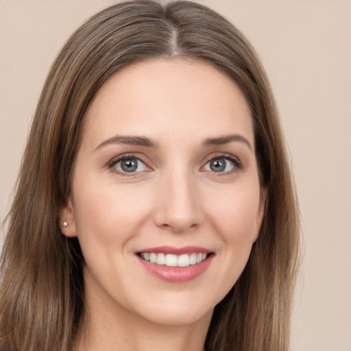 Joyful white young-adult female with long  brown hair and grey eyes