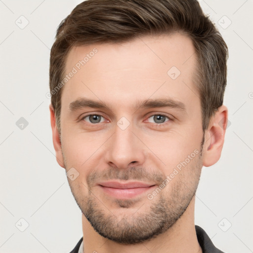 Joyful white young-adult male with short  brown hair and brown eyes