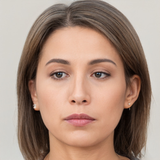 Neutral white young-adult female with medium  brown hair and brown eyes