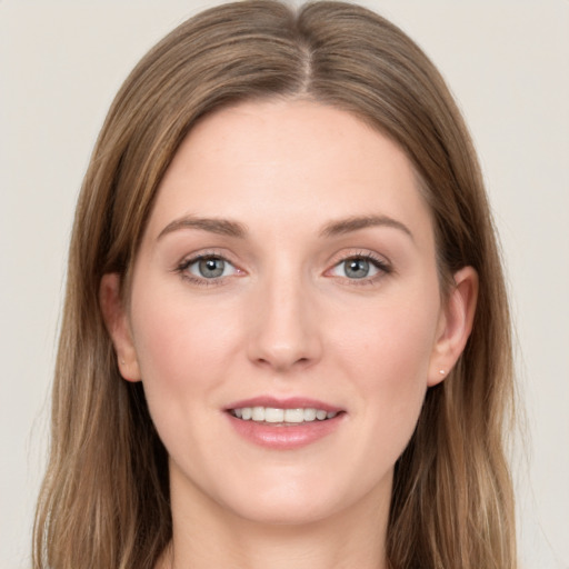 Joyful white young-adult female with long  brown hair and grey eyes