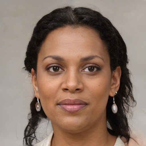 Joyful black young-adult female with medium  brown hair and brown eyes