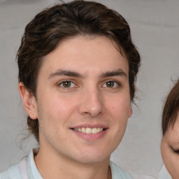 Joyful white young-adult male with medium  brown hair and brown eyes