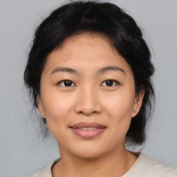 Joyful asian young-adult female with medium  brown hair and brown eyes