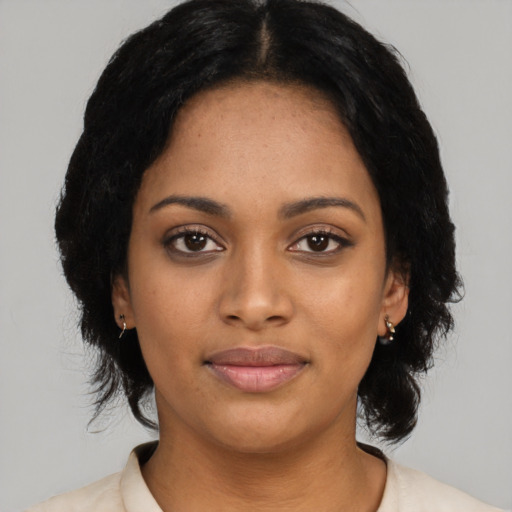Joyful black young-adult female with medium  black hair and brown eyes