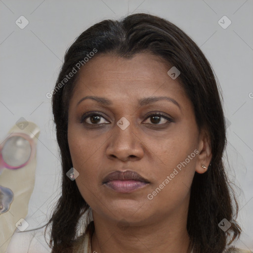 Joyful black adult female with long  brown hair and brown eyes