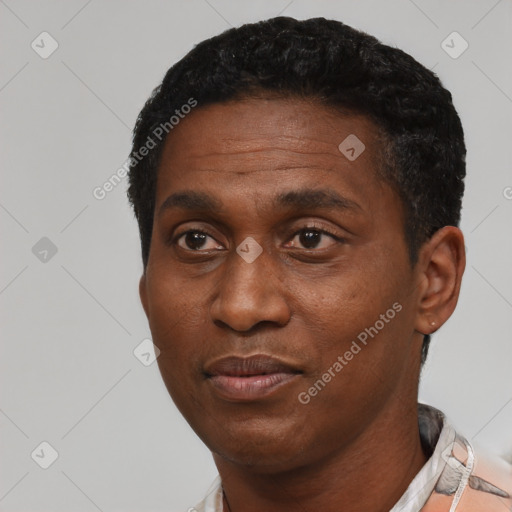 Joyful black adult male with short  black hair and brown eyes