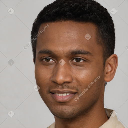 Joyful black young-adult male with short  black hair and brown eyes