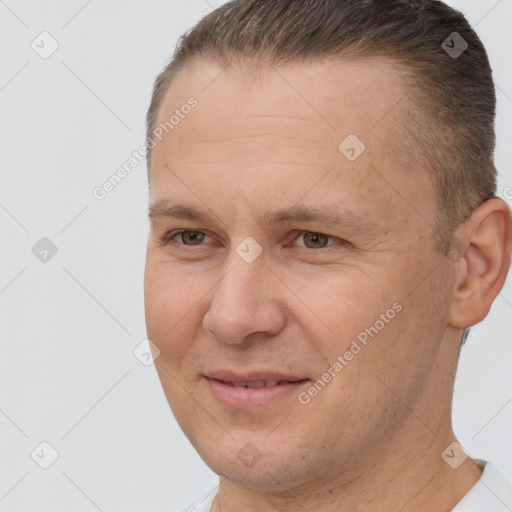 Joyful white adult male with short  brown hair and brown eyes