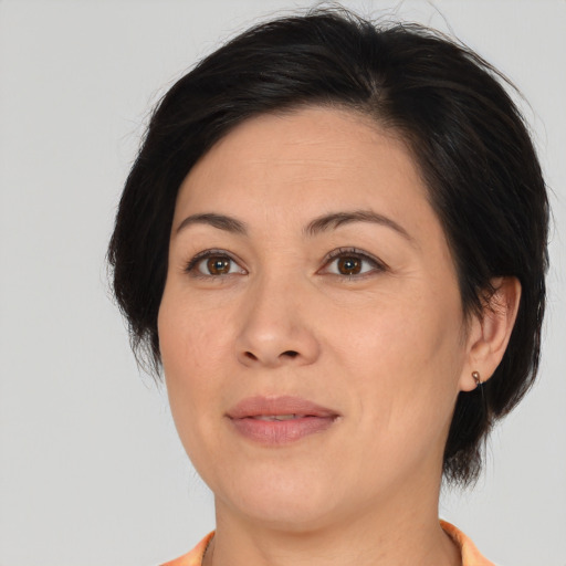Joyful asian adult female with medium  brown hair and brown eyes