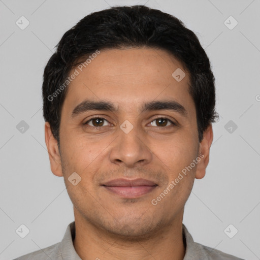 Joyful latino young-adult male with short  black hair and brown eyes