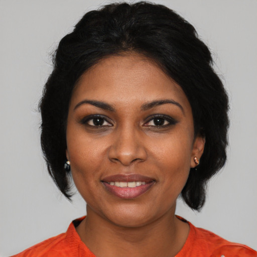 Joyful black young-adult female with medium  black hair and brown eyes