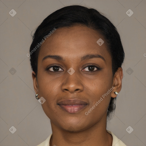 Joyful black young-adult female with short  black hair and brown eyes