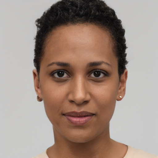 Joyful black young-adult female with short  brown hair and brown eyes