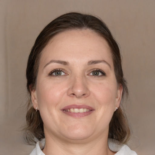 Joyful white adult female with medium  brown hair and brown eyes