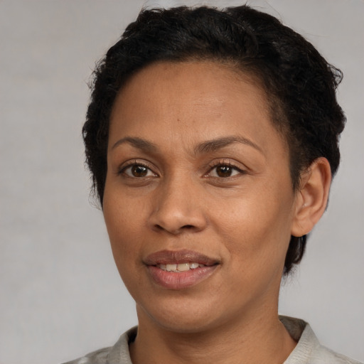 Joyful latino adult female with short  black hair and brown eyes