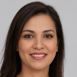 Joyful white young-adult female with long  brown hair and brown eyes