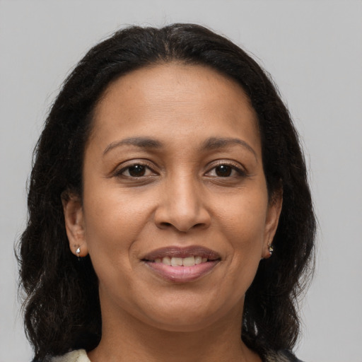 Joyful latino adult female with long  brown hair and brown eyes