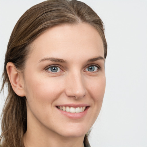 Joyful white young-adult female with long  brown hair and grey eyes