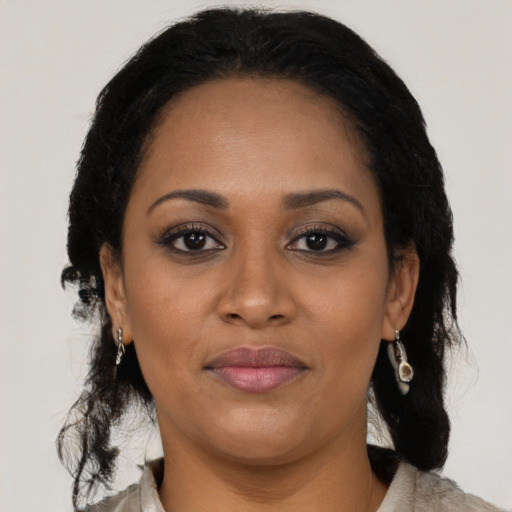 Joyful black adult female with medium  black hair and brown eyes