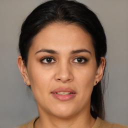 Joyful latino young-adult female with medium  brown hair and brown eyes