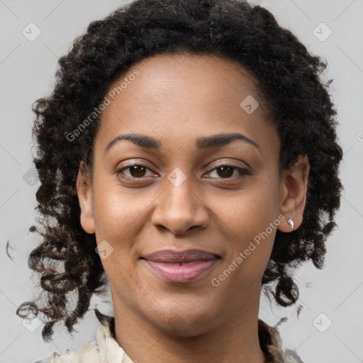 Joyful black young-adult female with long  brown hair and brown eyes