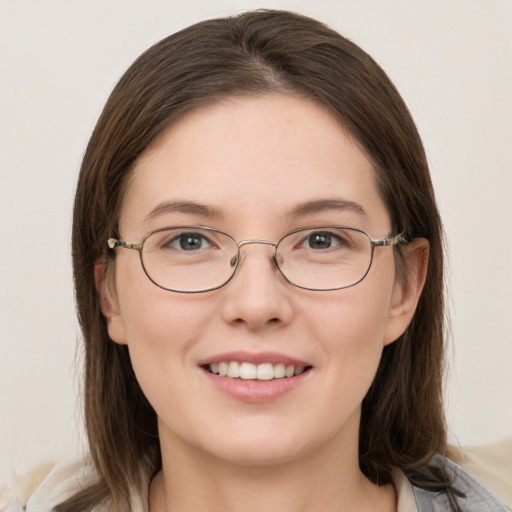 Joyful white young-adult female with medium  brown hair and grey eyes