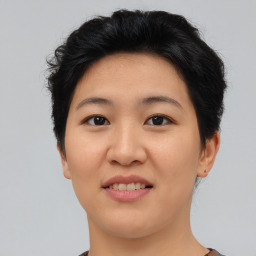 Joyful asian young-adult female with short  brown hair and brown eyes