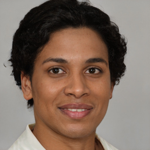 Joyful latino adult female with short  brown hair and brown eyes