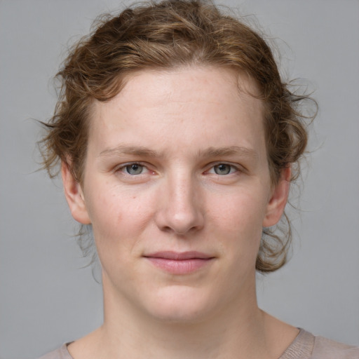 Joyful white young-adult female with medium  brown hair and blue eyes